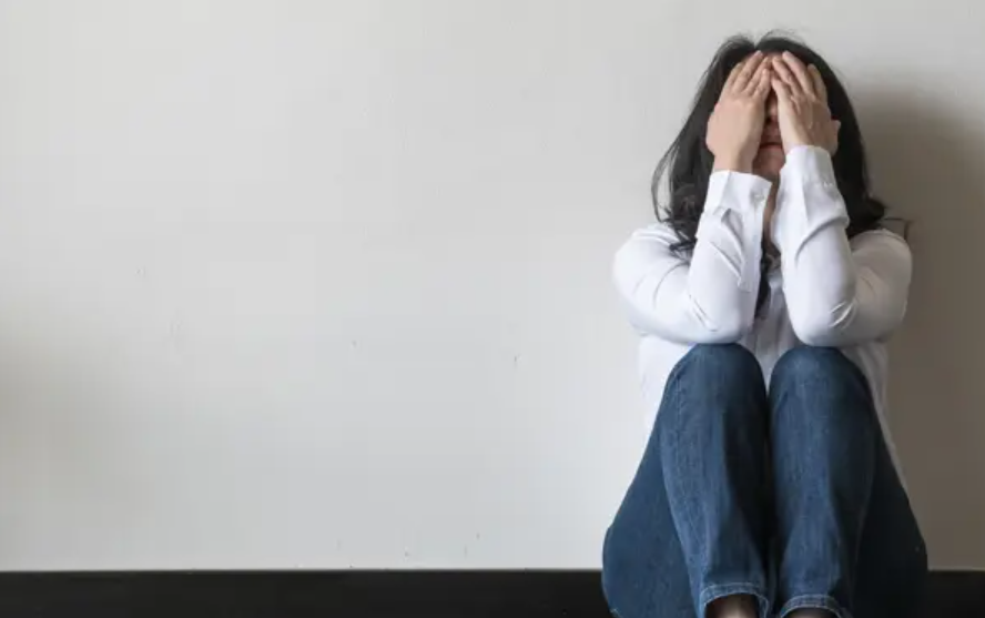 women with head in hands